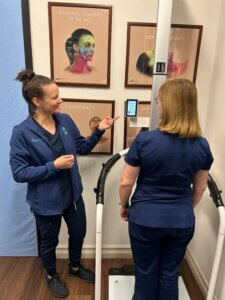 FNP and patient using the Seca body scan analysis machine at Maloney Plastic Surgery